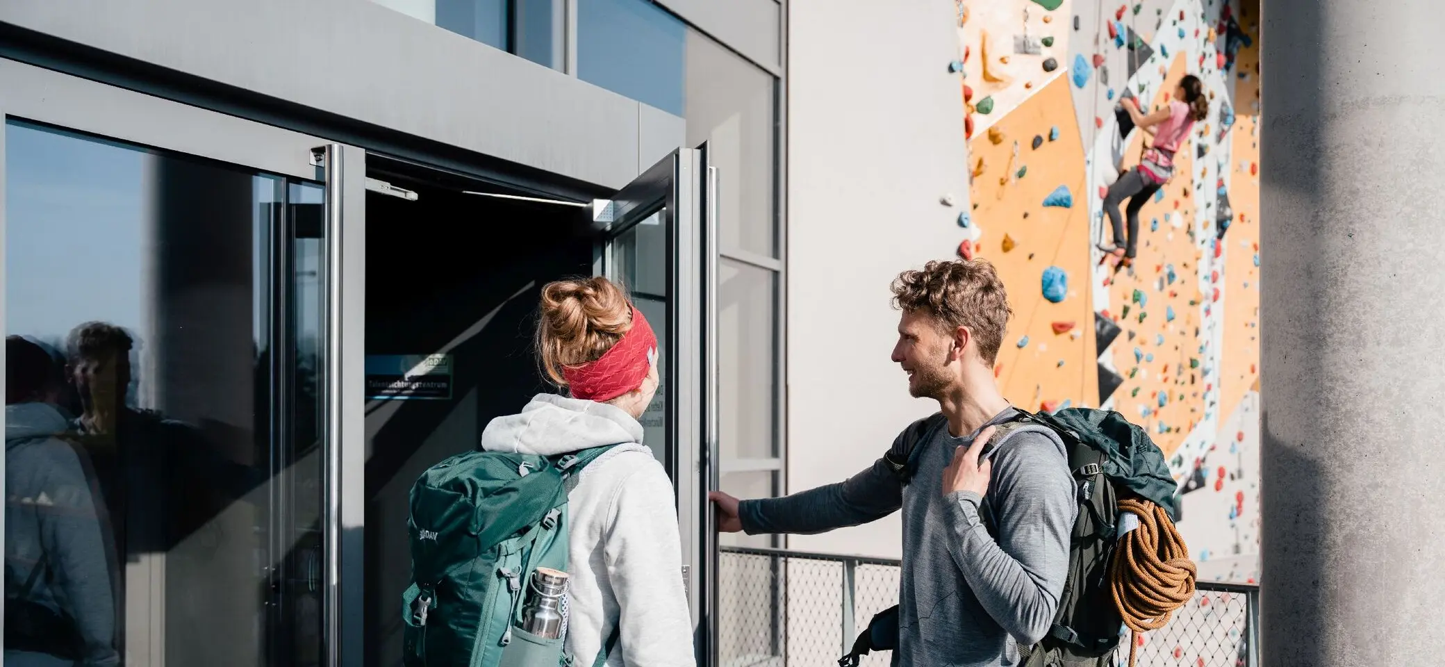 Zwei Personen öffnen die Tür zum Kletterzentrum | © DAV / Marisa Koch